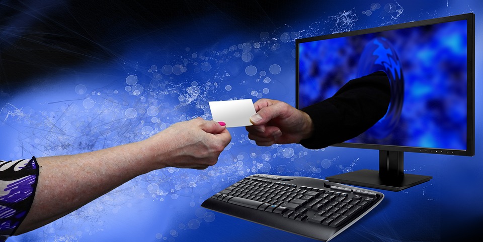 Hand coming out from a screen handing a piece of small paper